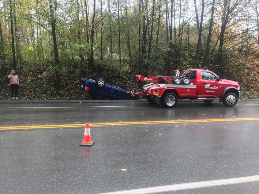 Image of overturned vehicle on side of the road